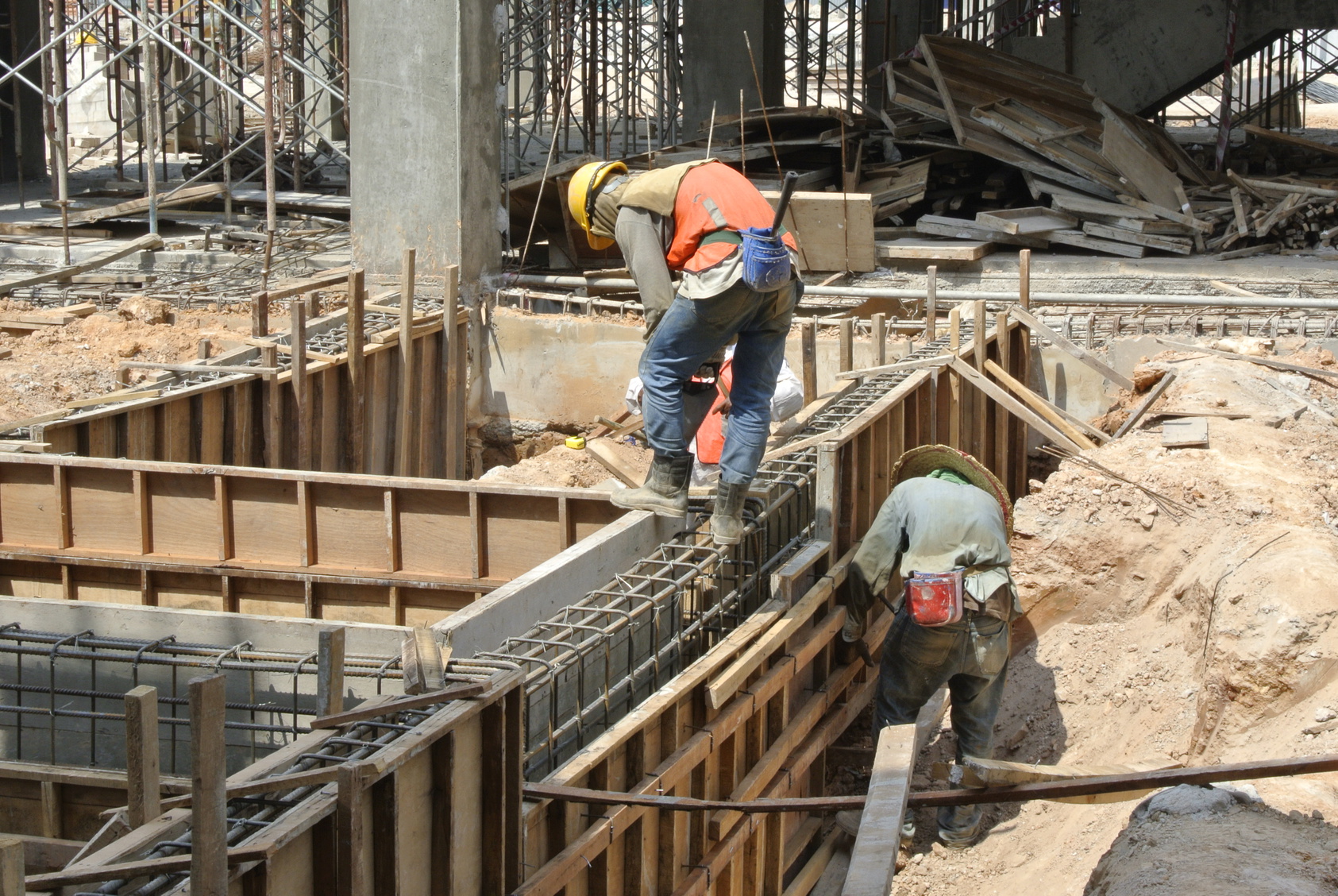 Two Construction Workers Installing Ground Beam Formwork